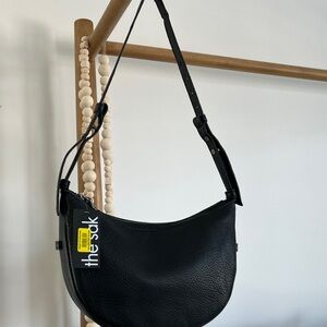 The Sak Black Pebbled Crescent Shoulder Bag with Adjustable Strap